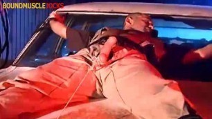 Muscular cop tied up on the car with his cock out